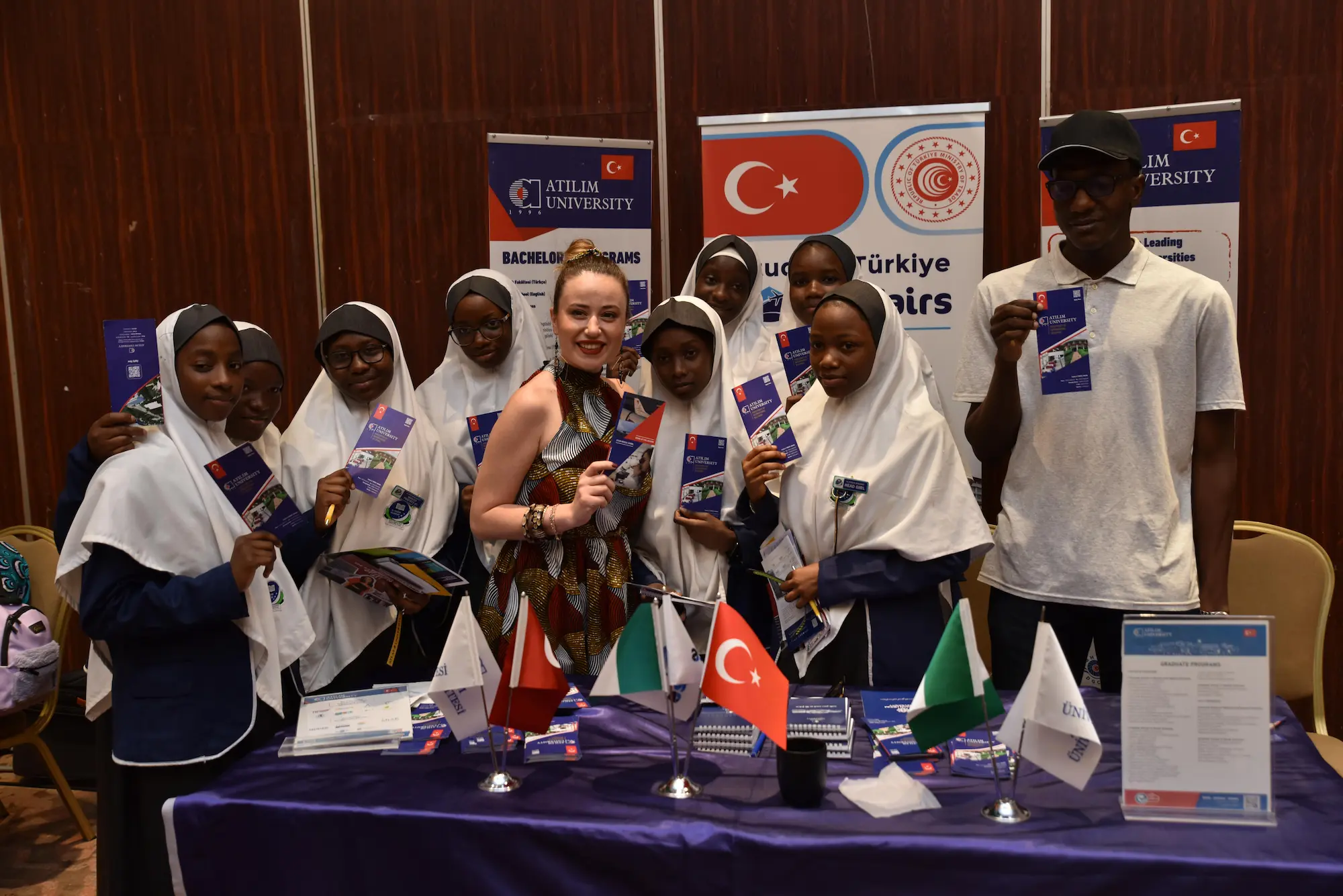 Students with brochures at education fair